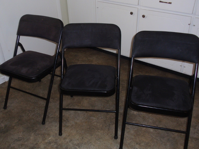 4 Black cushioned folding chairs