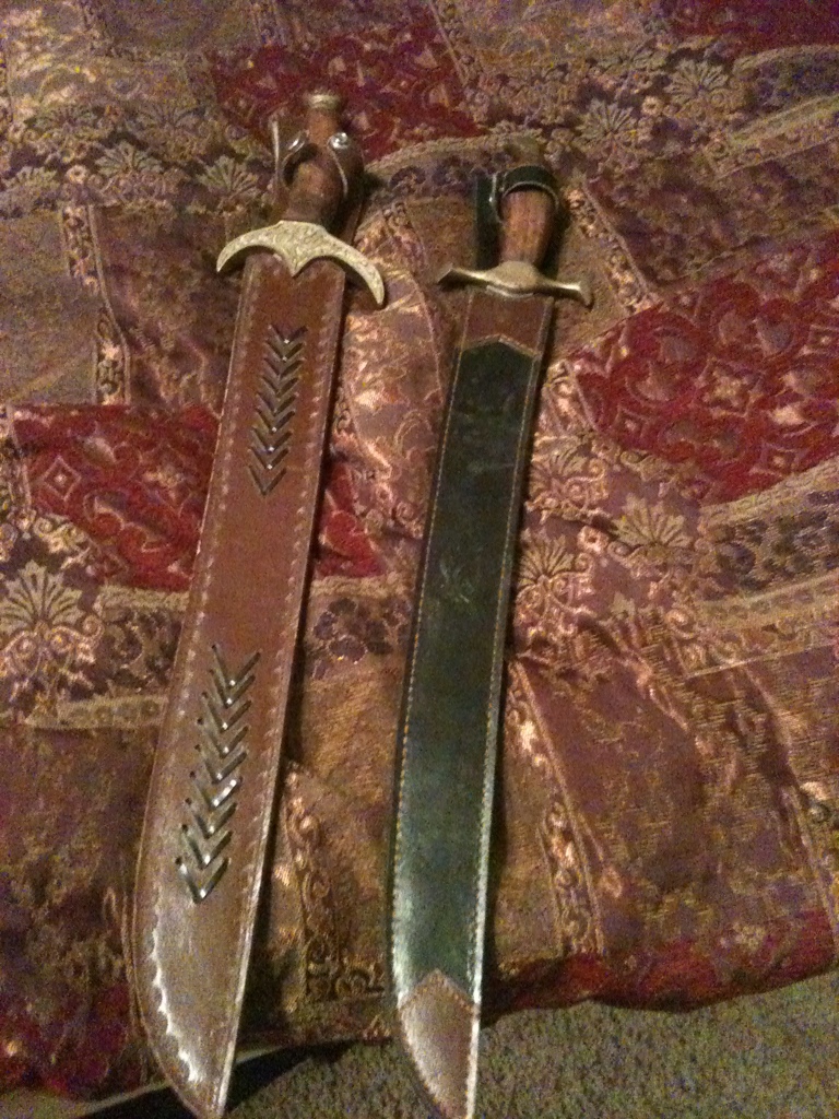 2 swords with leather scabbards