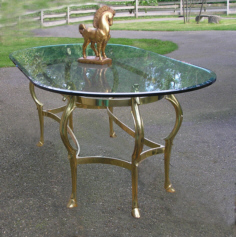 Glass table with horsehead brass base