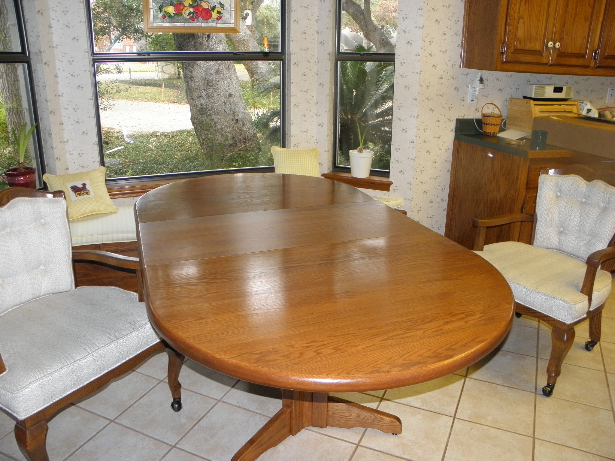 Oval kitchen table with 3 large chairs on casters