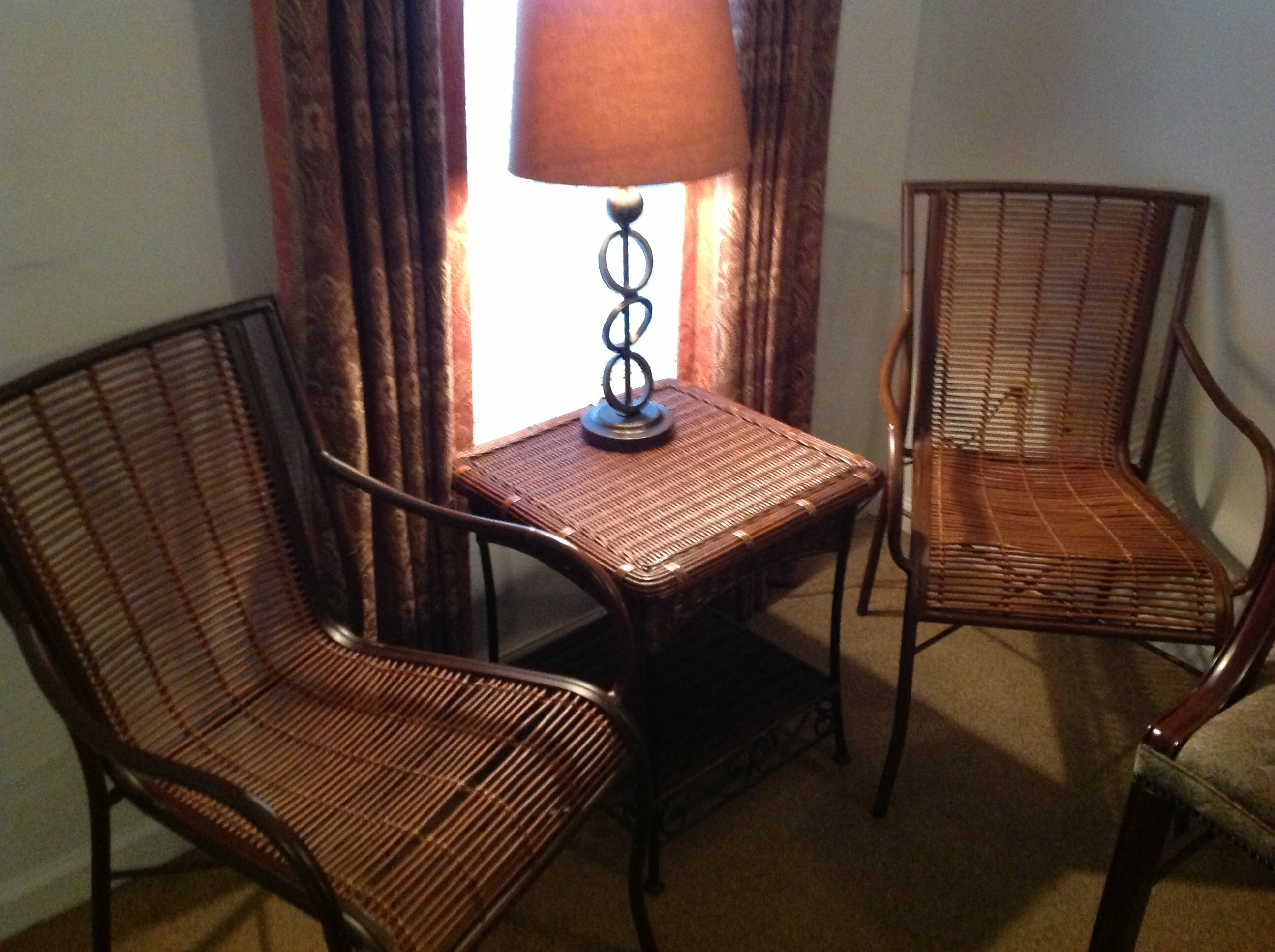Brown wicker chairs and small wicker table