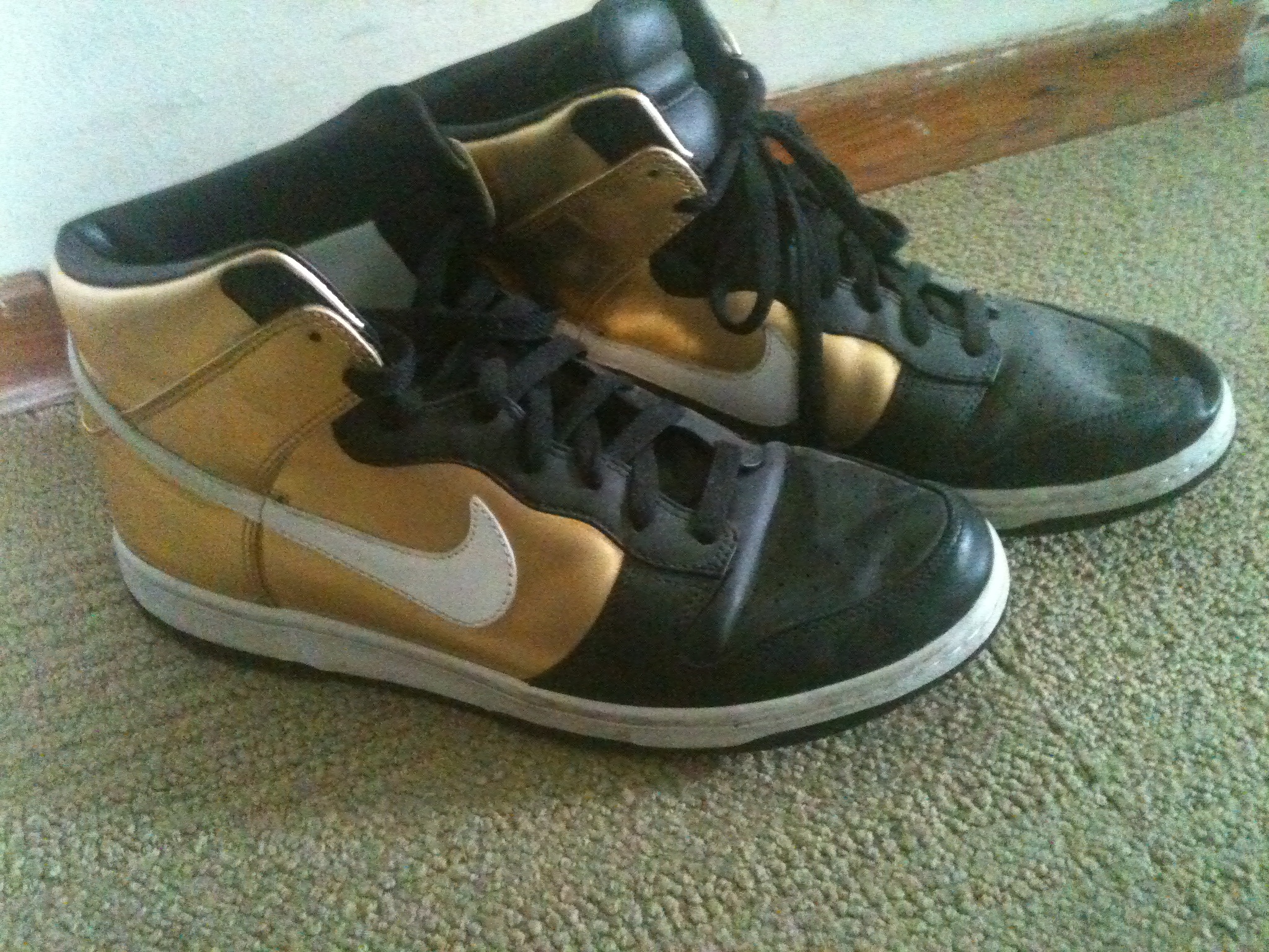 Pair of gold and black nikes