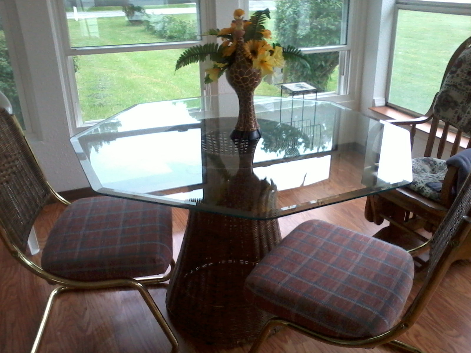 Glass table top with wicker stand and 4 cloth seats Wicker backs