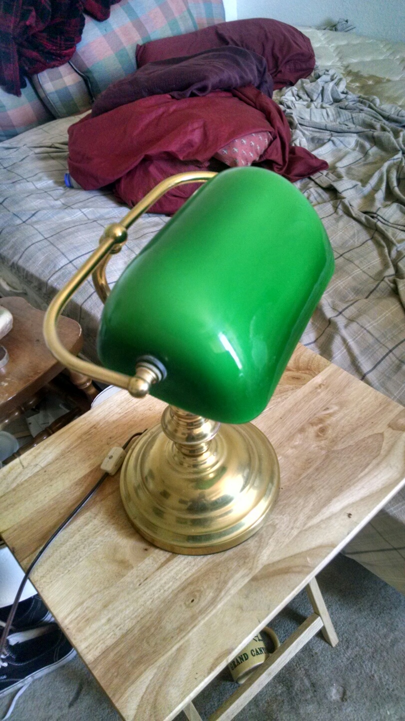 Brass desk lamp with emerald glass.