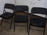 4 Black cushioned folding chairs